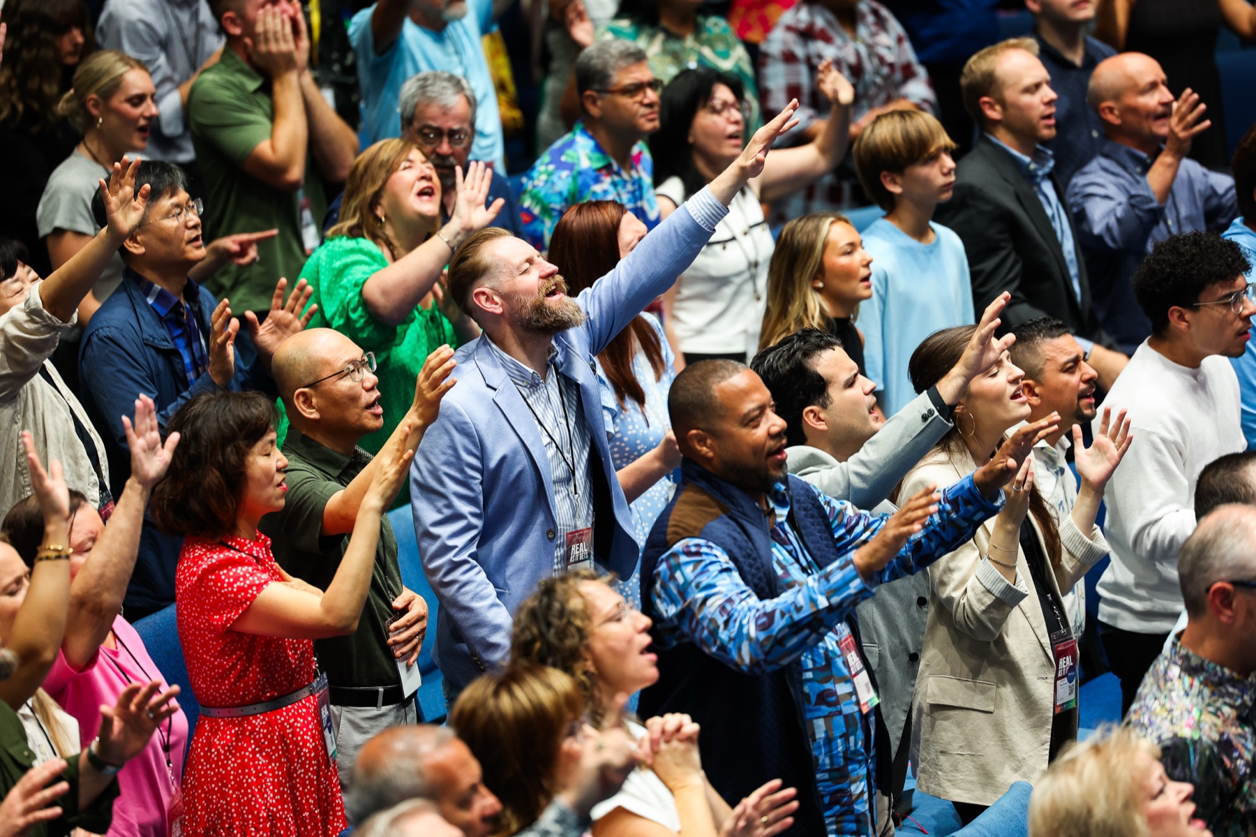 Congregation with hands raised in worship