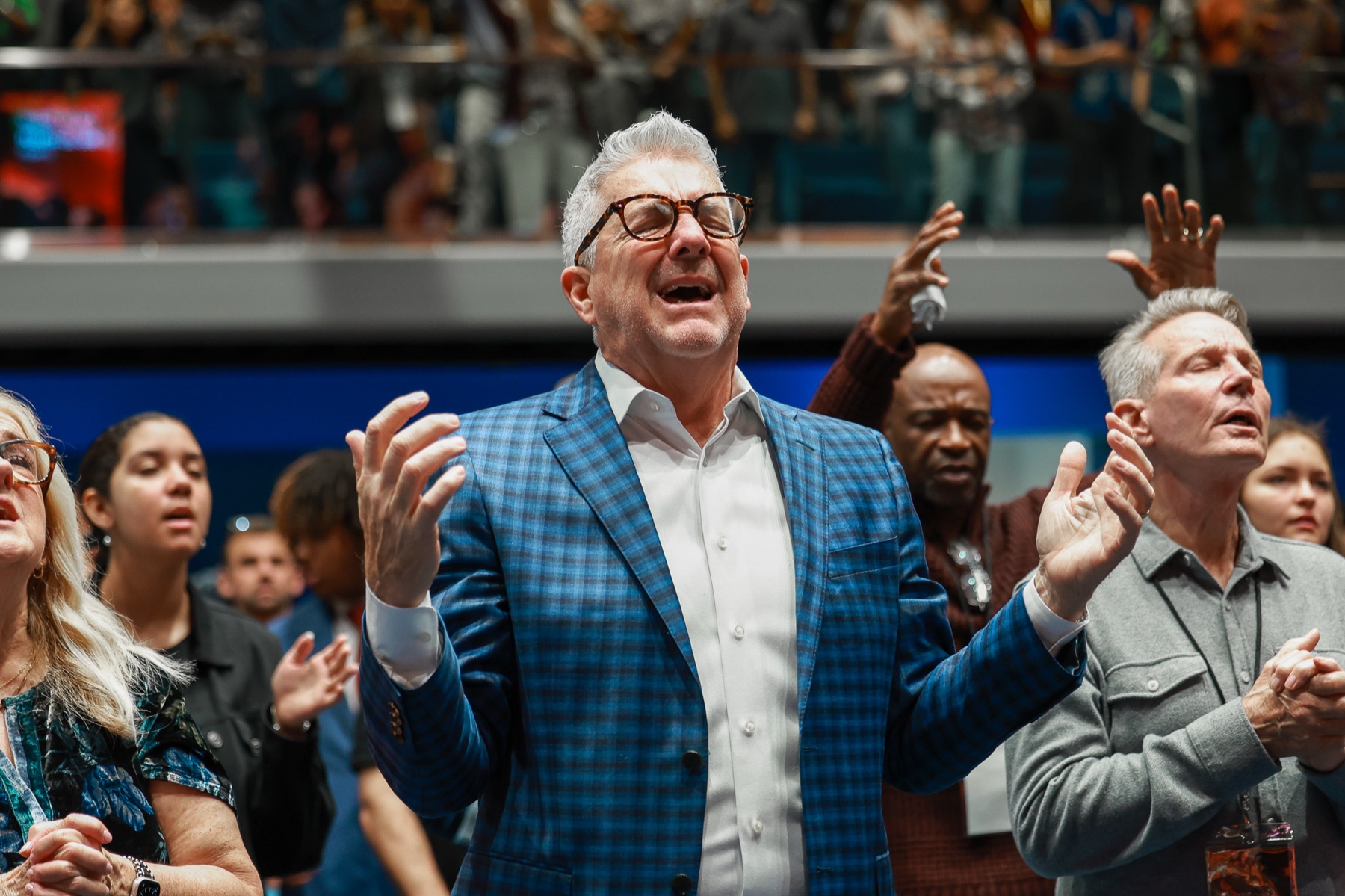 A leader worshipping with hands raised