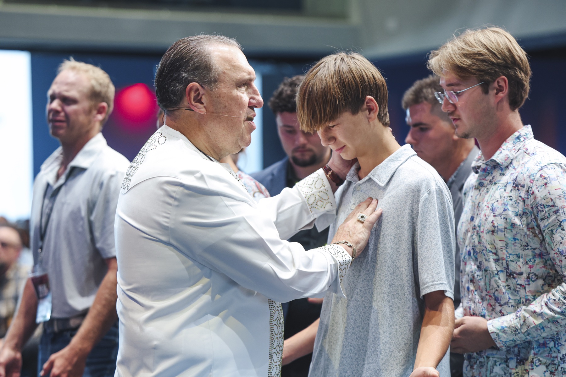 Dr. Rodney Howard-Browne praying over a young man